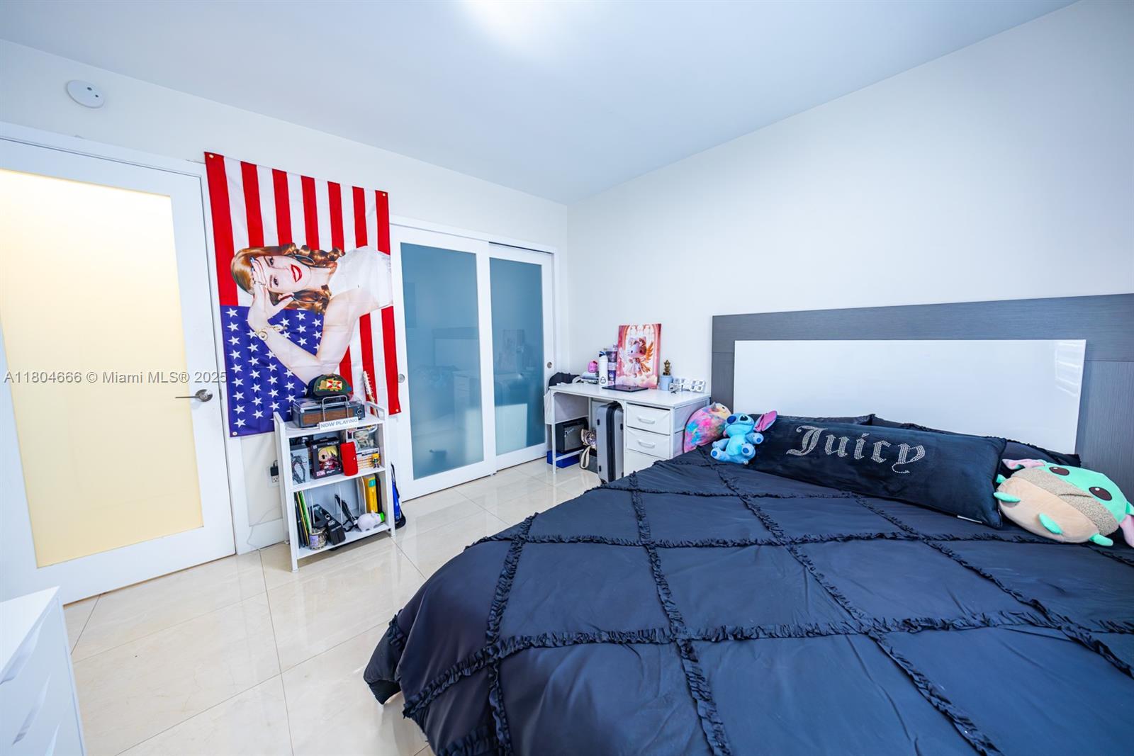 6950 Northwest 168th Street Hialeah, FL 33015 - Photo 18 of 28 a bedroom with a bed and a window