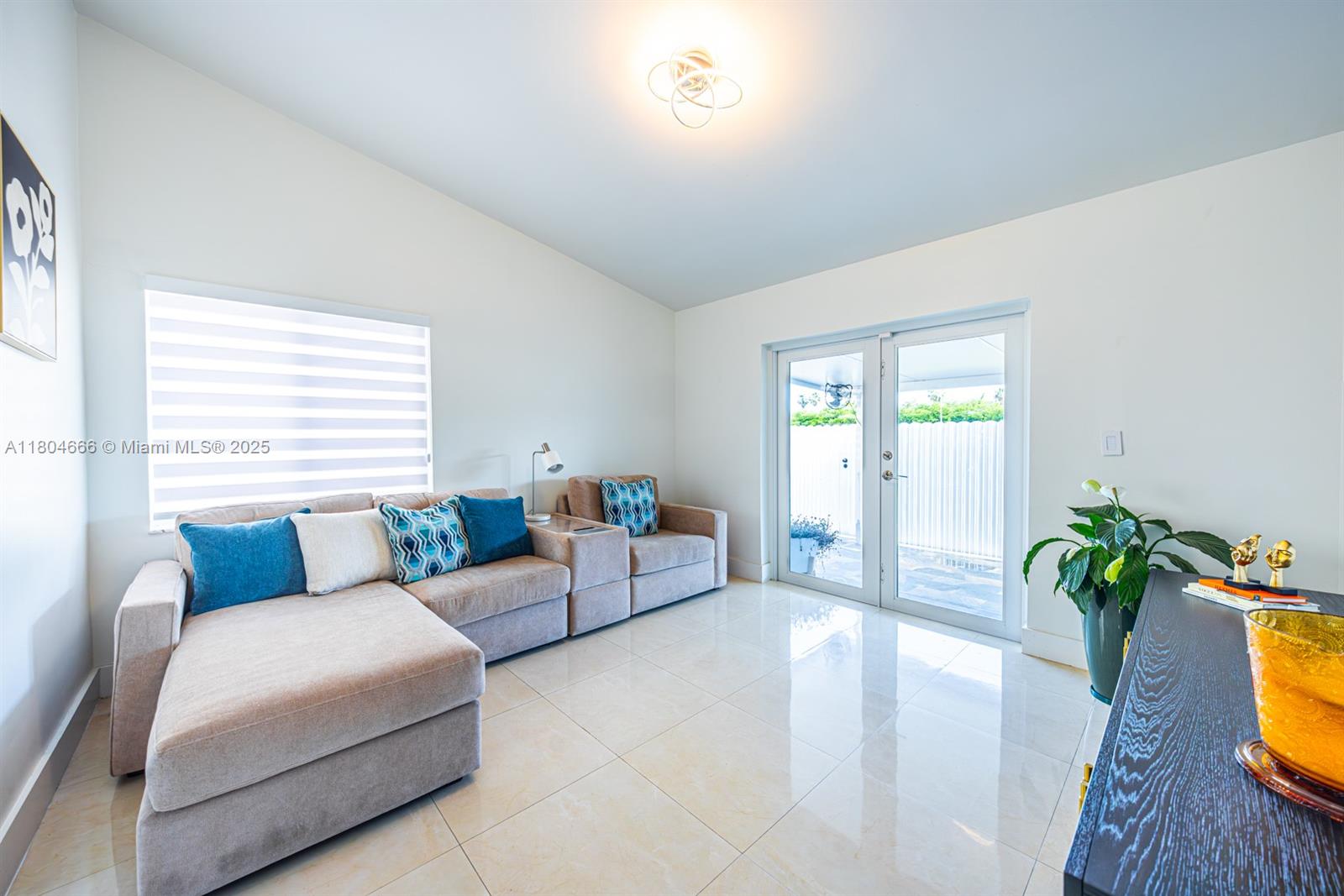 6950 Northwest 168th Street Hialeah, FL 33015 - Photo 21 of 28 a living room with furniture and a potted plant