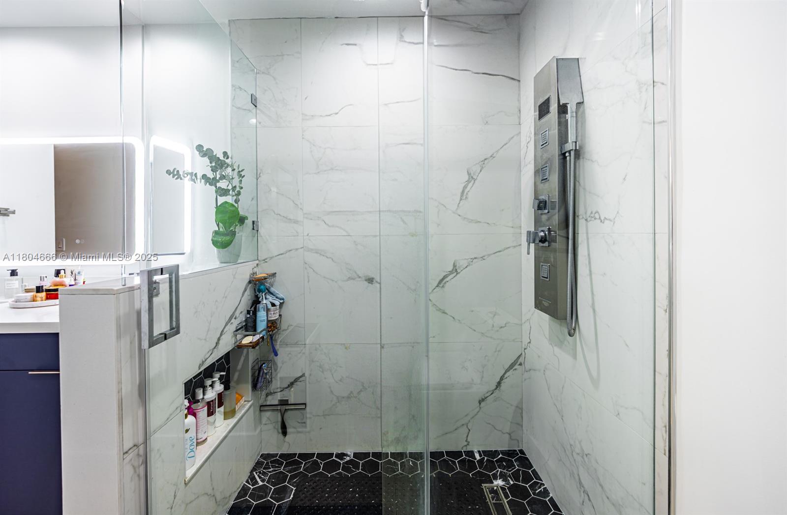 6950 Northwest 168th Street Hialeah, FL 33015 - Photo 27 of 28 a bathroom with a shower and a sink