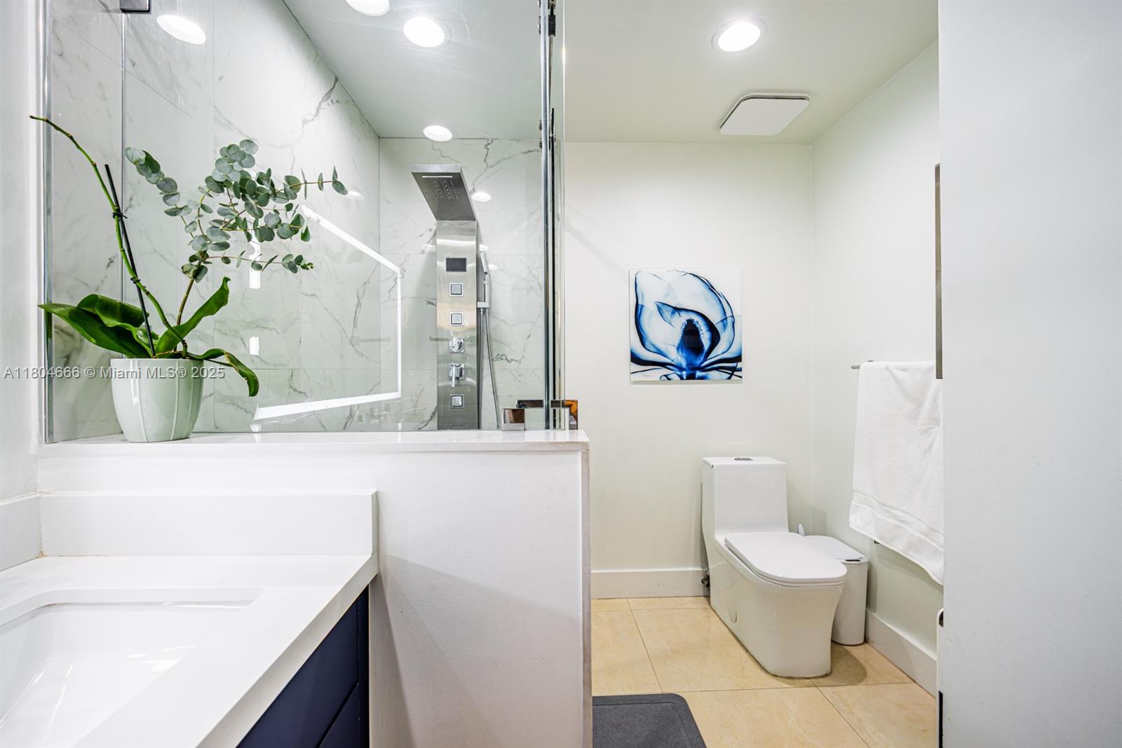 6950 Northwest 168th Street Hialeah, FL 33015 - Photo 28 of 28 a bathroom with a toilet sink and mirror