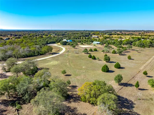 an aerial view of a house with yard