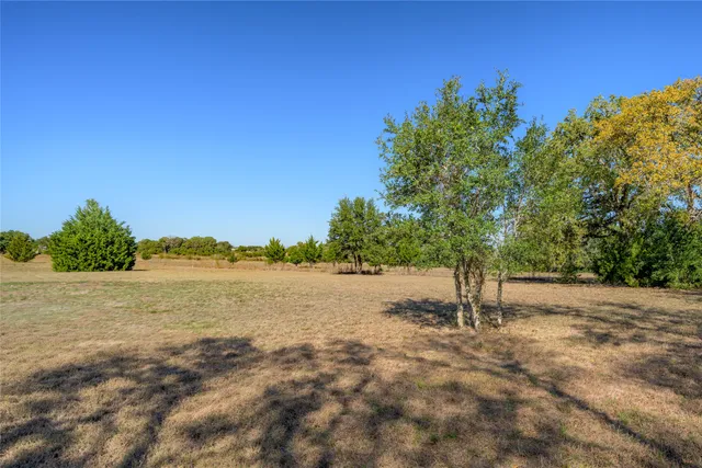 a view of a lake with a yard