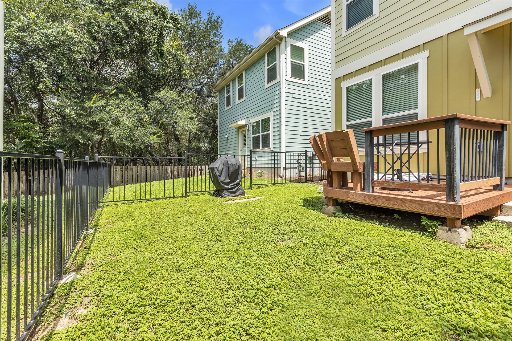 12212 Tawny Farms Road, Unit 142 Austin, TX 78748 - Photo 17 of 21 A compact backyard space, fully fenced for privacy, includes a raised patio for outdoor enjoyment.