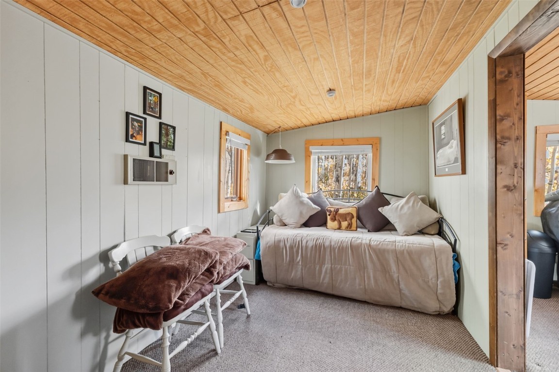 5364 Meadow Creek Road Tabernash, CO 80478 - Photo 4 of 30 a bedroom with a bed and glass windows