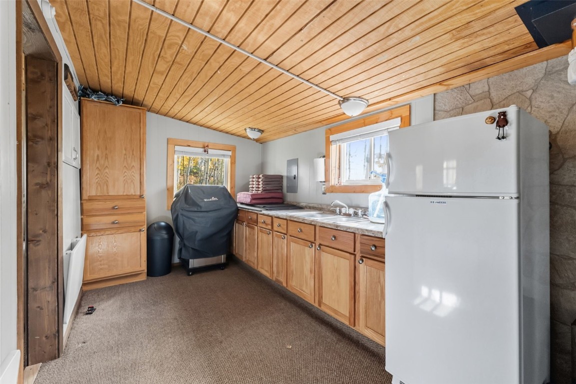 5364 Meadow Creek Road Tabernash, CO 80478 - Photo 5 of 30 a kitchen with refrigerator a stove and cabinets