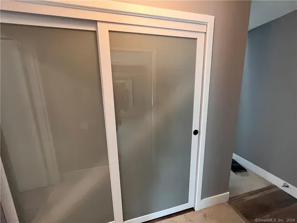 a bathroom with a glass shower door