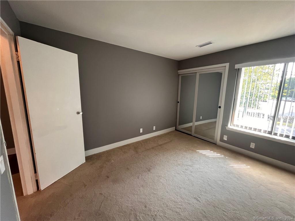 60 Olcott Way, Unit 60 Ridgefield, CT 06877 - Photo 17 of 31 an empty room with windows