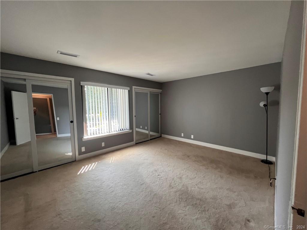 60 Olcott Way, Unit 60 Ridgefield, CT 06877 - Photo 19 of 31 a view of a big room with windows and chandelier