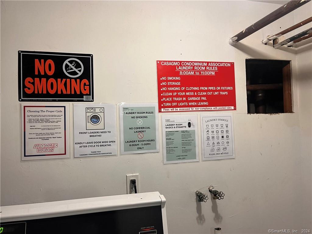60 Olcott Way, Unit 60 Ridgefield, CT 06877 - Photo 25 of 31 a view of a hallway with paintings on the wall and a potted plant