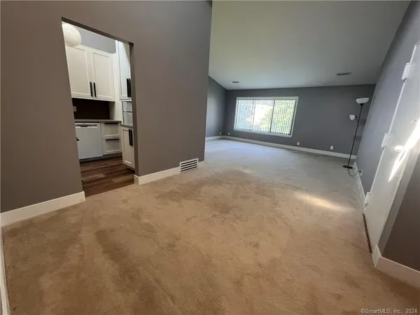 a view of empty room with a fireplace