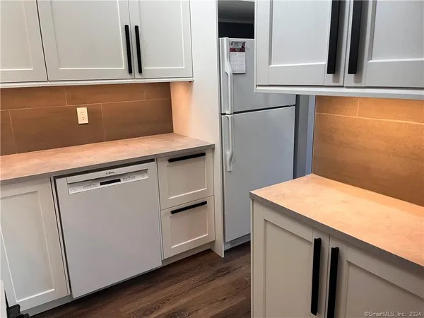 a kitchen with stainless steel appliances granite countertop a refrigerator and a sink
