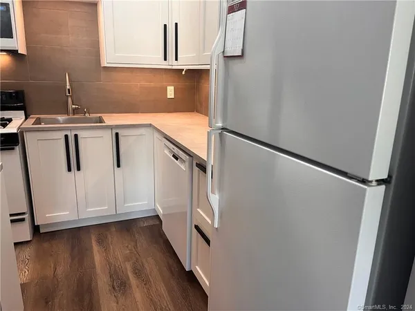 a view of cabinets and wooden floor