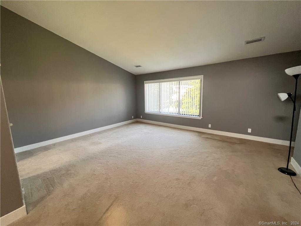 60 Olcott Way, Unit 60 Ridgefield, CT 06877 - Photo 10 of 31 an empty room with windows
