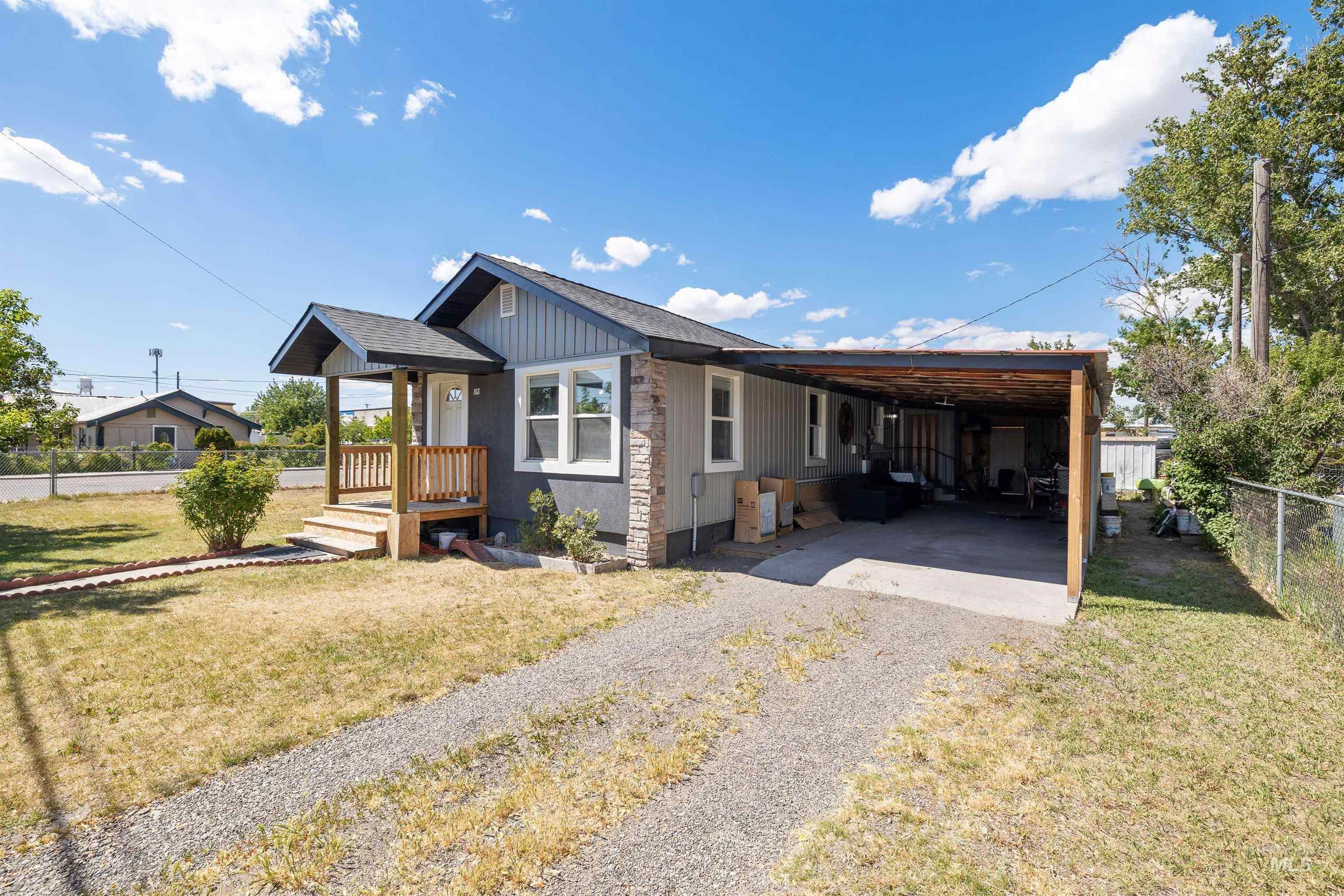 102 East 6th Street Rupert, ID 83350 - Photo 25 of 27 Single-story residence featuring a covered front porch with natural wood railings and steps