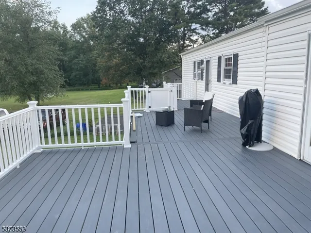 a view of a big yard with a house in the background