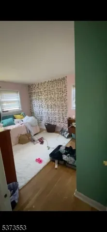 a bedroom with a bed couch and a window