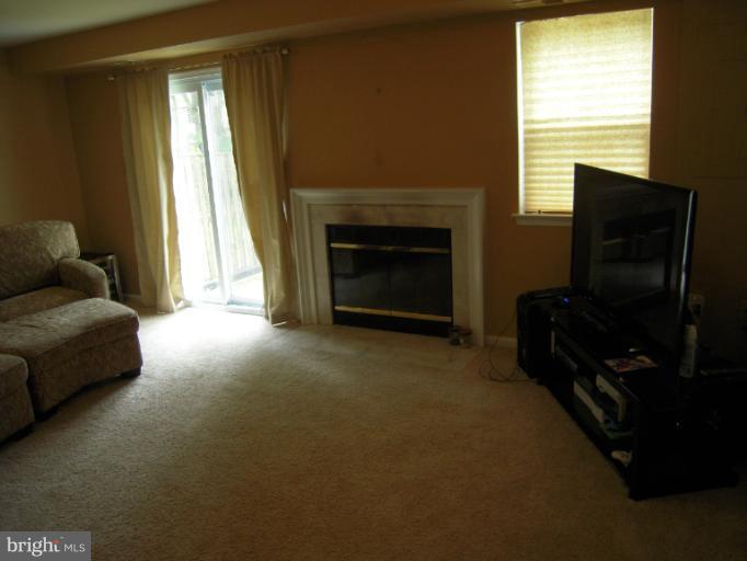 5478 Stavendish Street Burke, VA 22015 - Photo 12 of 30 a living room with furniture and a fireplace