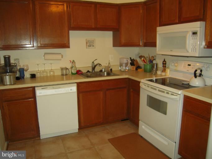 5478 Stavendish Street Burke, VA 22015 - Photo 17 of 30 a kitchen with a sink stove top oven and cabinets