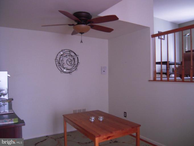 5478 Stavendish Street Burke, VA 22015 - Photo 24 of 30 a room with a table and a fan