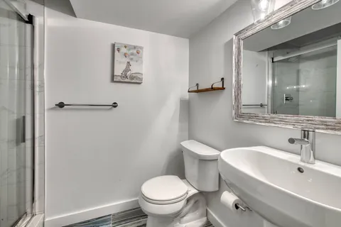 a white toilet sitting next to a bathroom sink