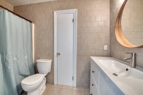 a white toilet sitting next to a bathroom sink