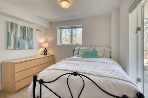 a bedroom with a bed and window