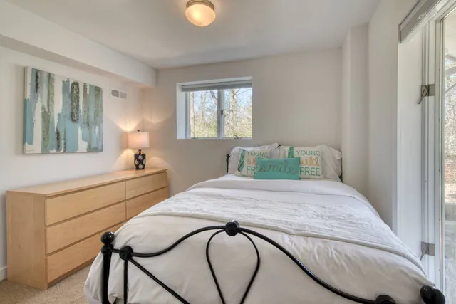 a bedroom with a bed and window