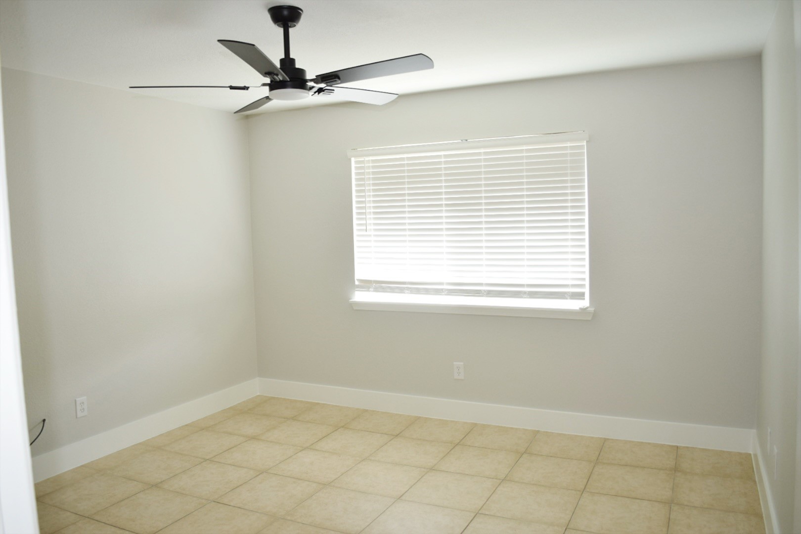 2324 Peppermill Road Houston, TX 77080 - Photo 13 of 20 Spacious primary bedroom with modern ceiling fan, large window for natural light.