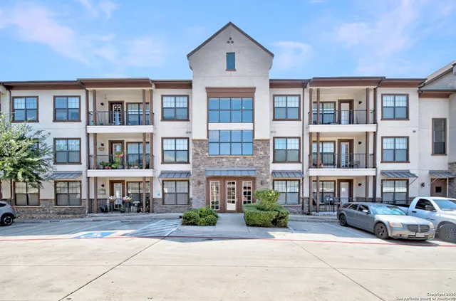 a front view of a residential apartment building with a yard