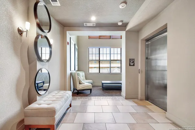 a living room with furniture a mirror and a window