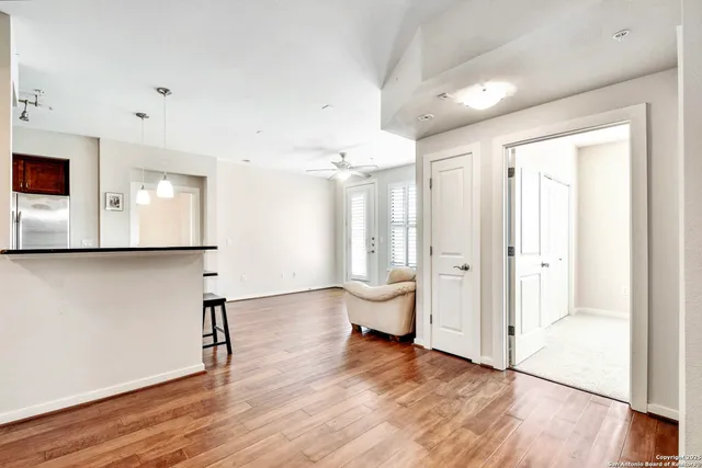 a view of empty room with wooden floor