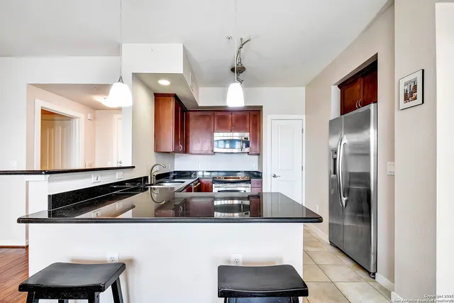 a kitchen with a sink refrigerator and microwave