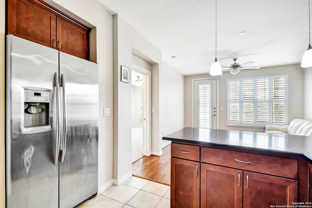 a kitchen with stainless steel appliances granite countertop a refrigerator and a sink