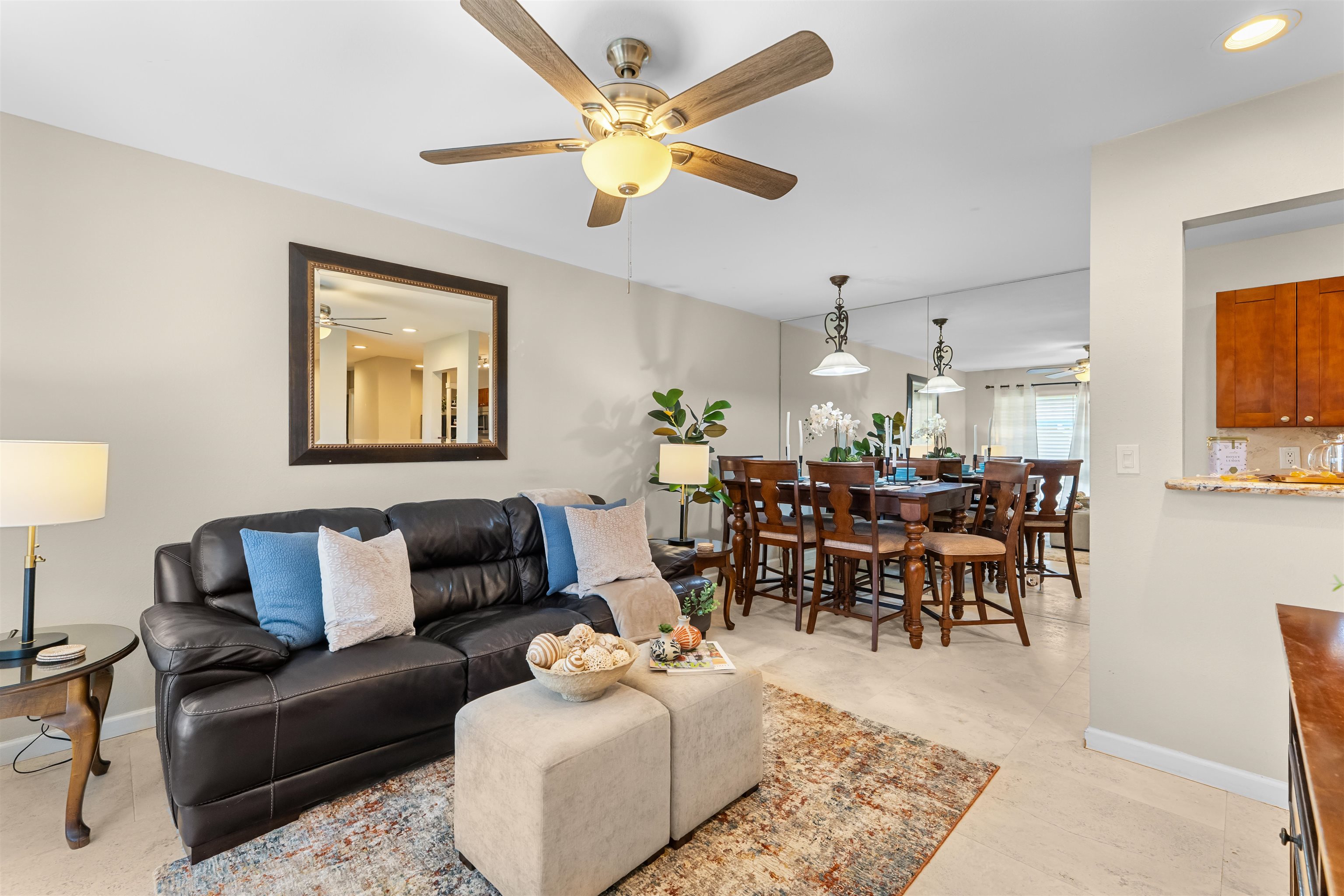 a living room with furniture potted plant and a chandelier