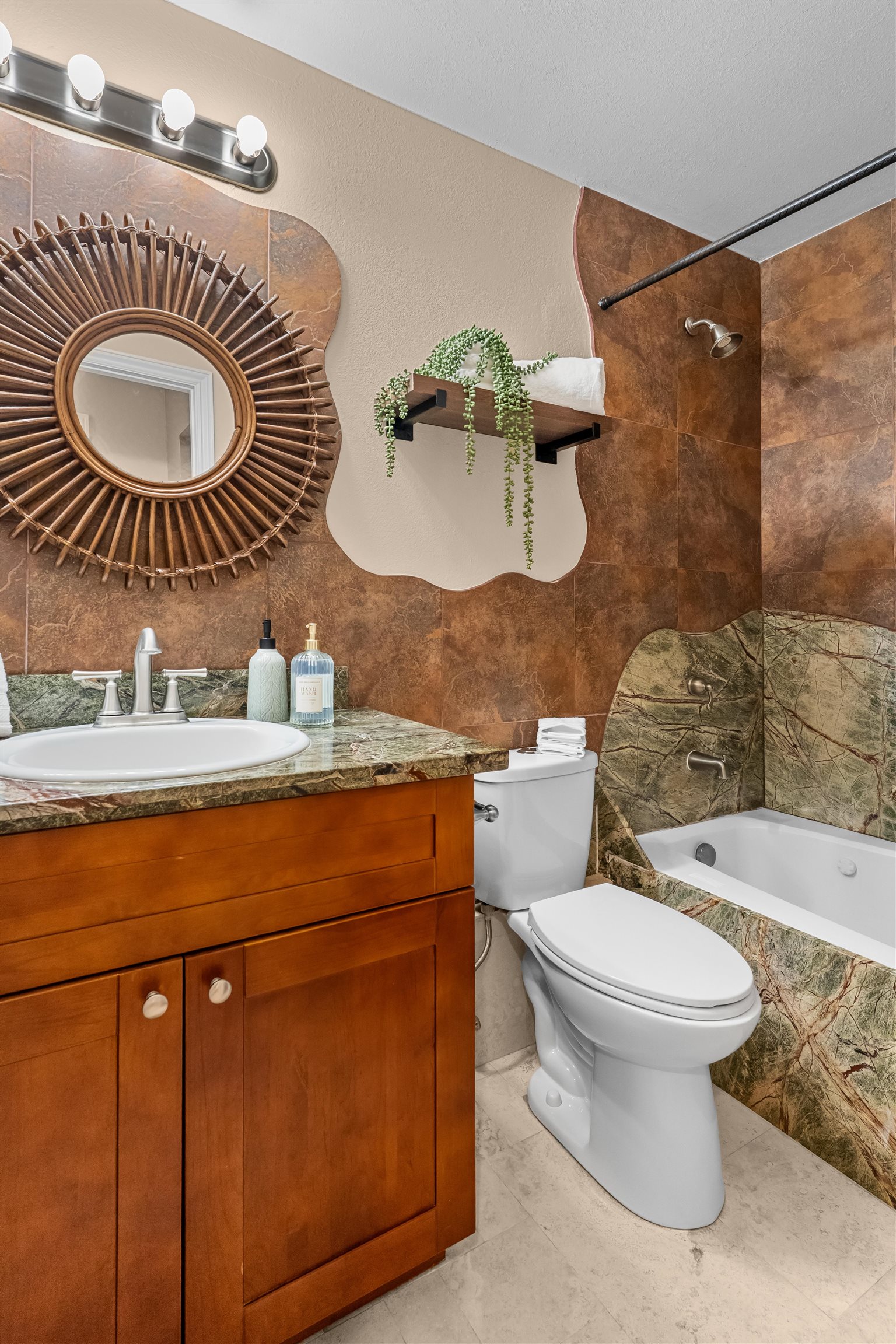 480 Kenolio Road, Unit 1203 Kihei, HI 96753 - Photo 13 of 17 a bathroom with a toilet a sink and mirror