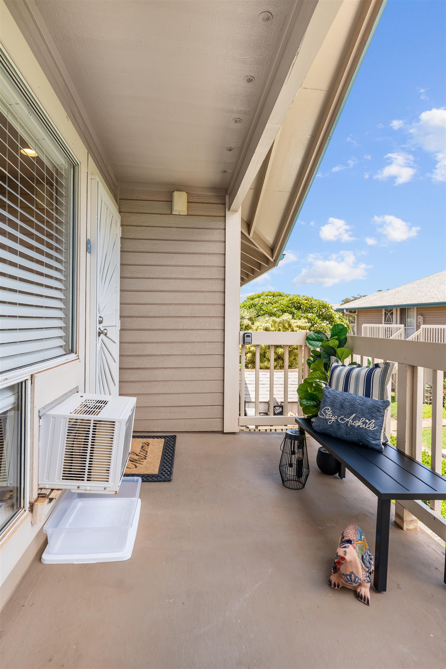 480 Kenolio Road, Unit 1203 Kihei, HI 96753 - Photo 2 of 17 a building outdoor space with patio furniture and potted plants