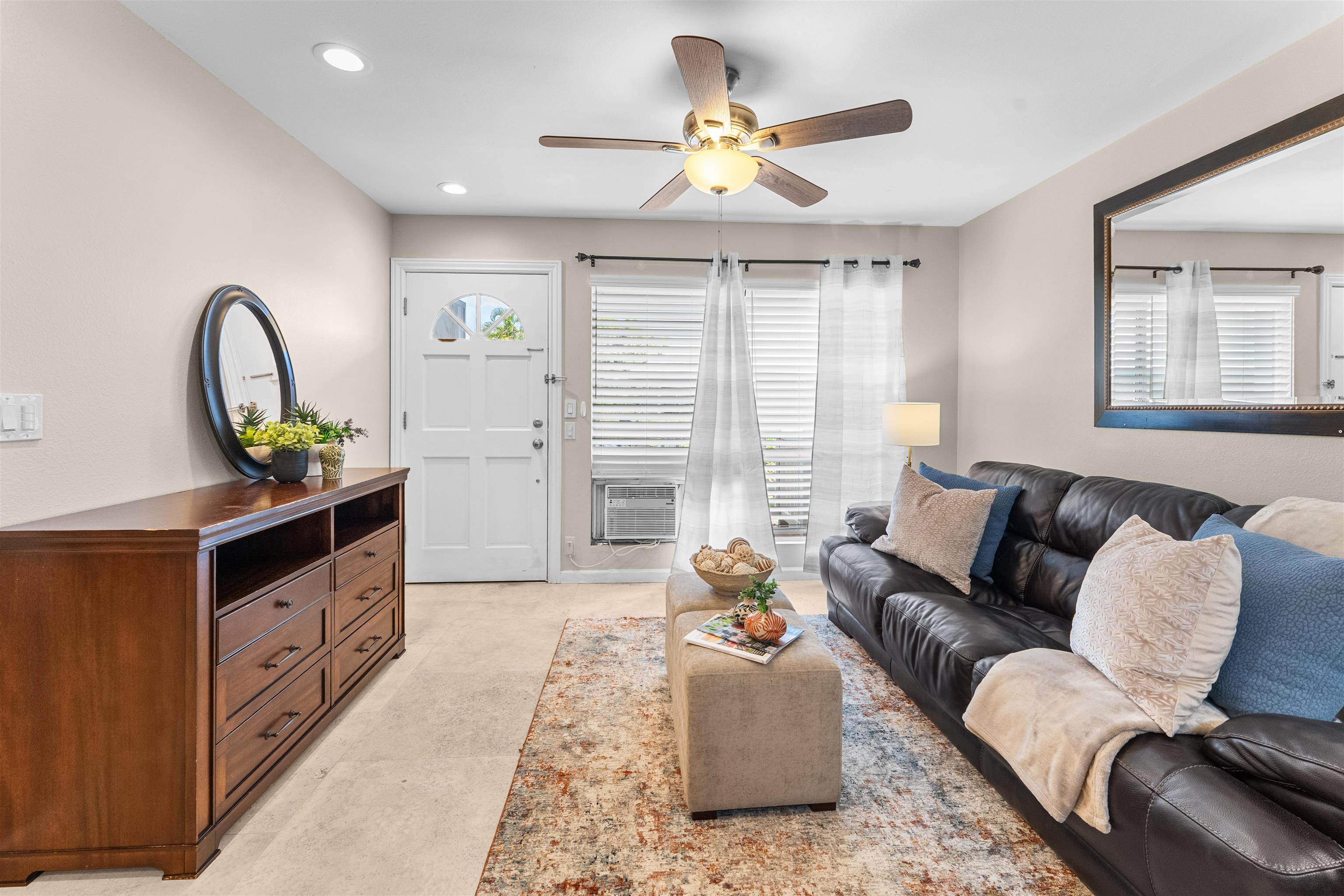 480 Kenolio Road, Unit 1203 Kihei, HI 96753 - Photo 3 of 17 a living room with furniture and a large window