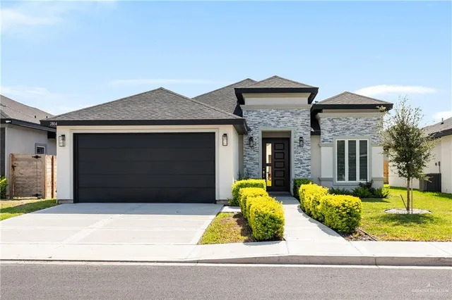 a front view of a house with garden