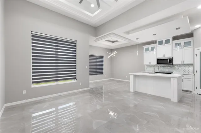 a view of kitchen and sink with cabinets