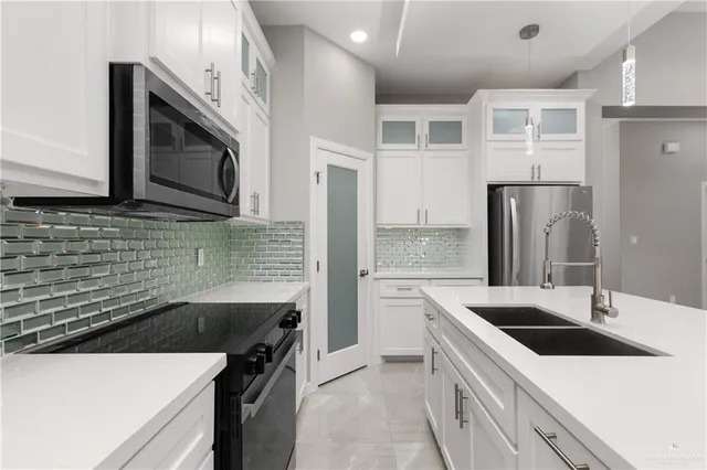 a kitchen that has a sink and a stove
