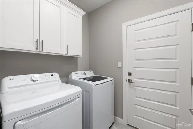 a view of storage and utility room with washer and dryer