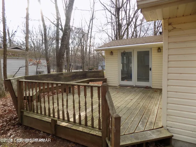 a view of a wooden house with a small yard
