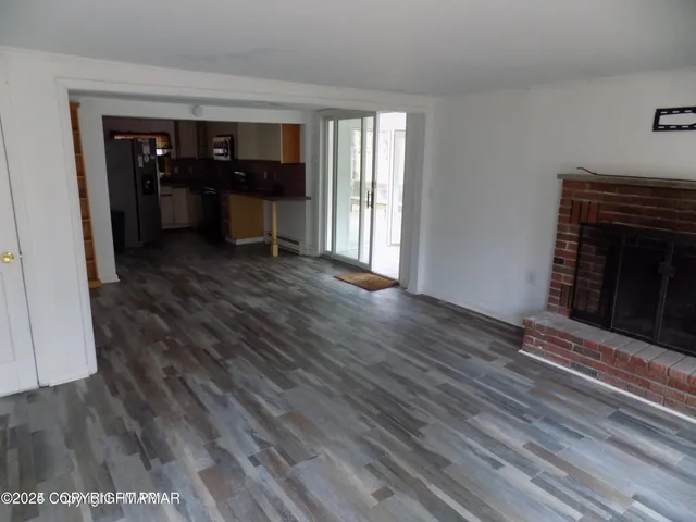 a view of kitchen with furniture and fireplace