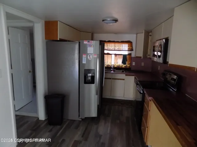 a kitchen with a refrigerator and a stove