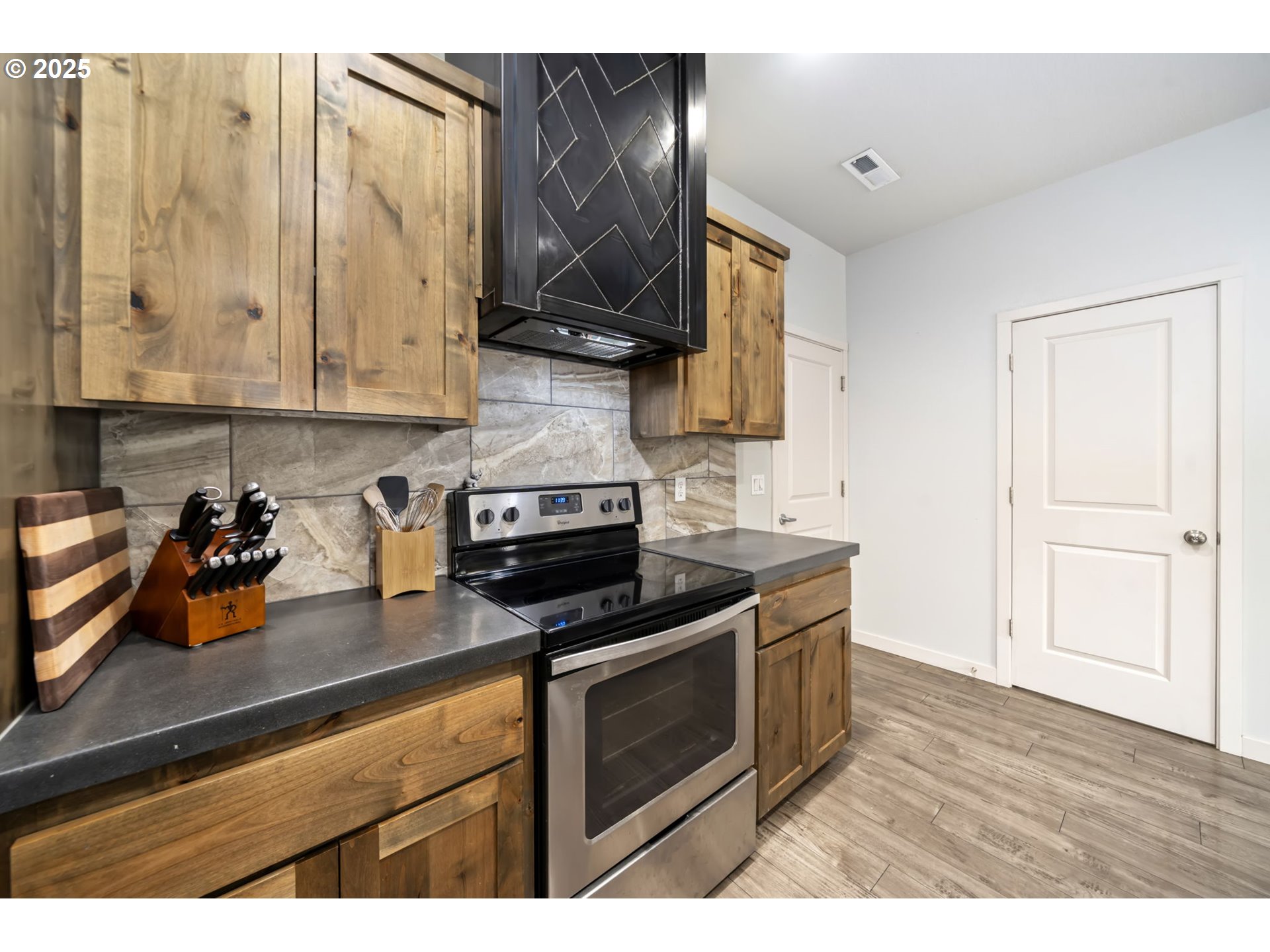 125 North 44th Place Ridgefield, WA 98642 - Photo 24 of 47 a kitchen with a sink a stove and cabinets
