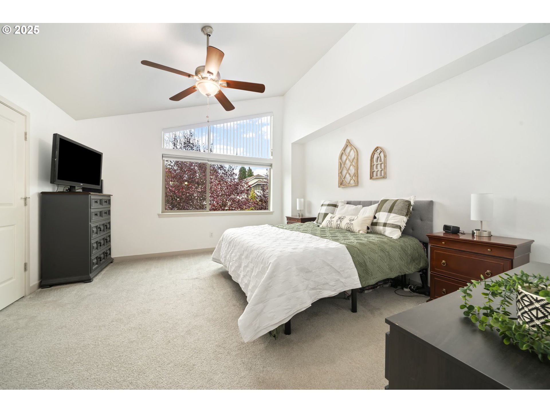 125 North 44th Place Ridgefield, WA 98642 - Photo 29 of 47 a bedroom with a bed and a flat tv screen on the dresser