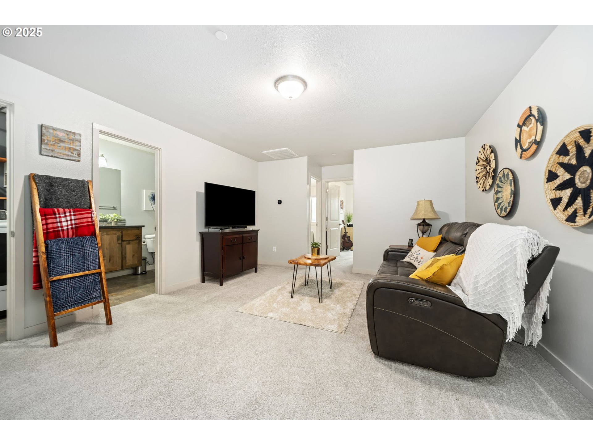 125 North 44th Place Ridgefield, WA 98642 - Photo 39 of 47 a living room with furniture and a flat screen tv