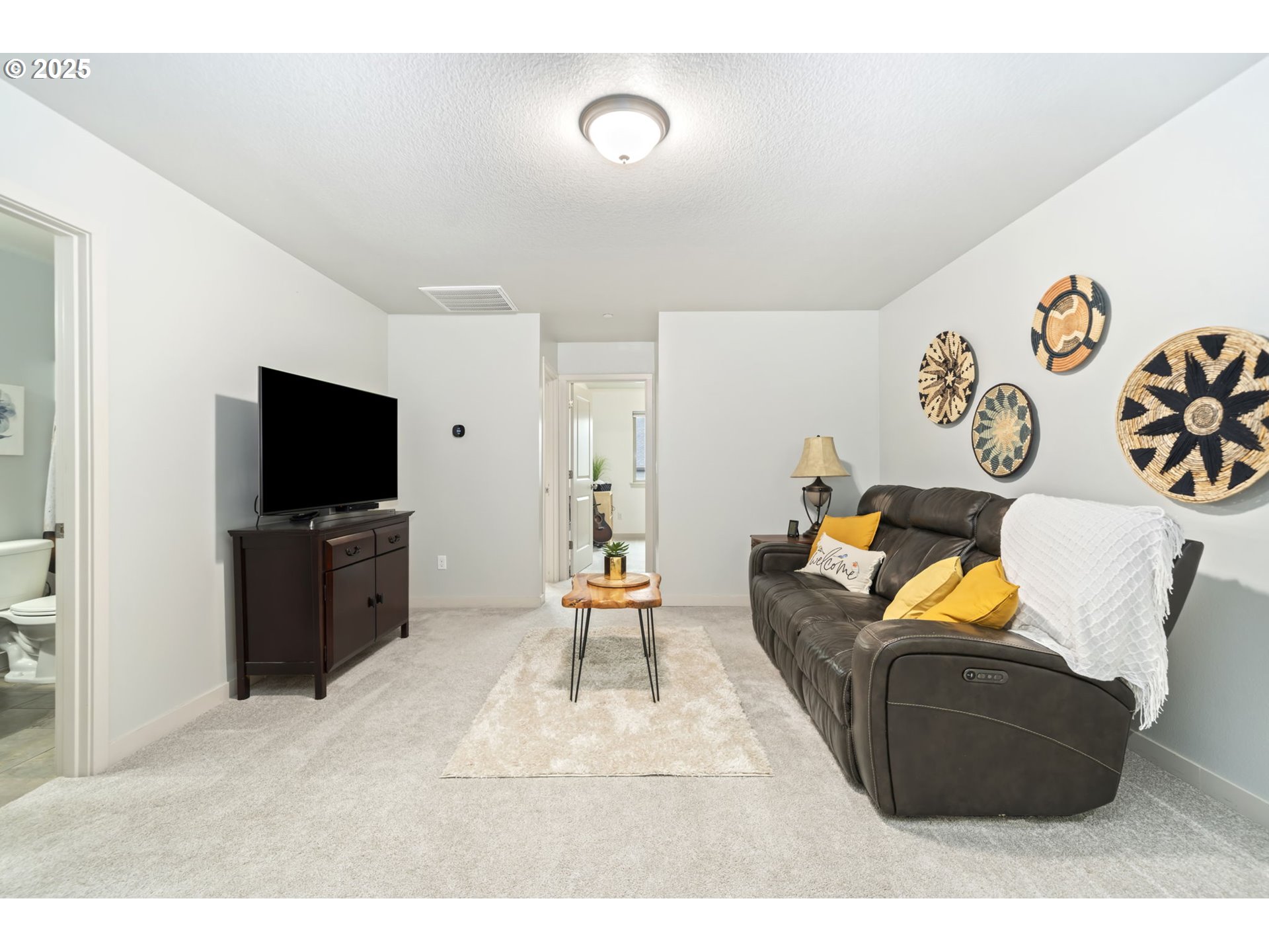 125 North 44th Place Ridgefield, WA 98642 - Photo 40 of 47 a living room with furniture and a flat screen tv