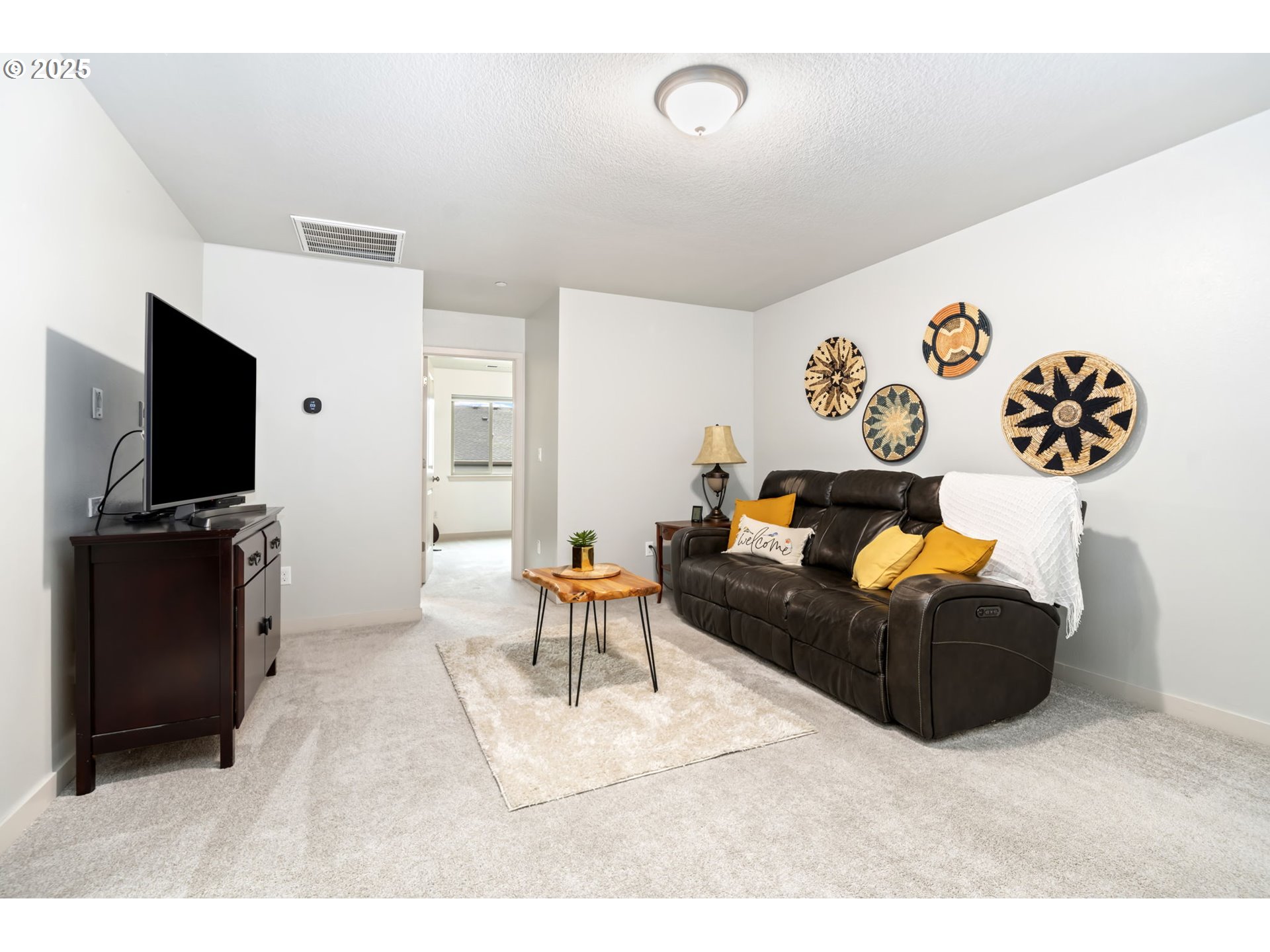 125 North 44th Place Ridgefield, WA 98642 - Photo 41 of 47 a living room with furniture and a flat screen tv