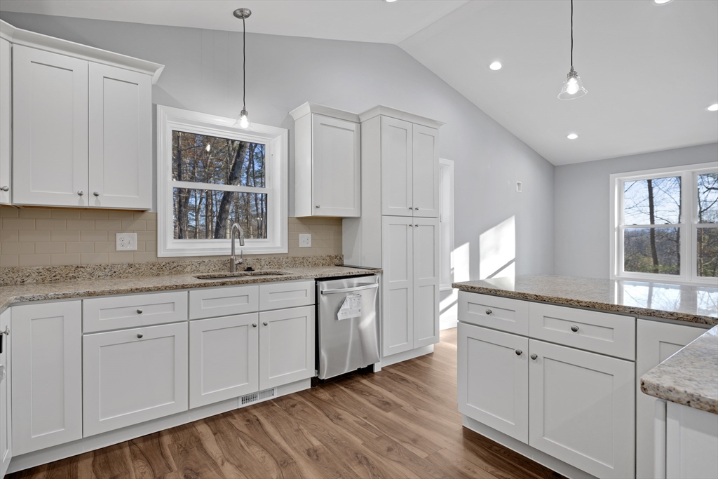 132 Kibbe Road East Longmeadow, MA 01028 - Photo 13 of 32 a kitchen with granite countertop white cabinets and white appliances with wooden floor